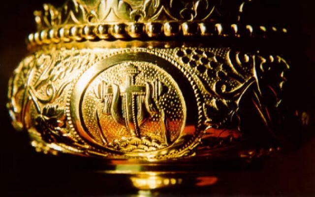 Engraved medallion of the Cross draped with the Holy Shroud