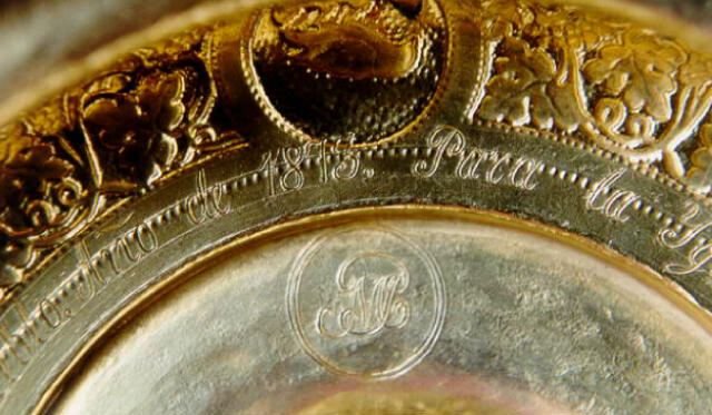 Underside of the chalice base showing the engraved P over M monogram and date